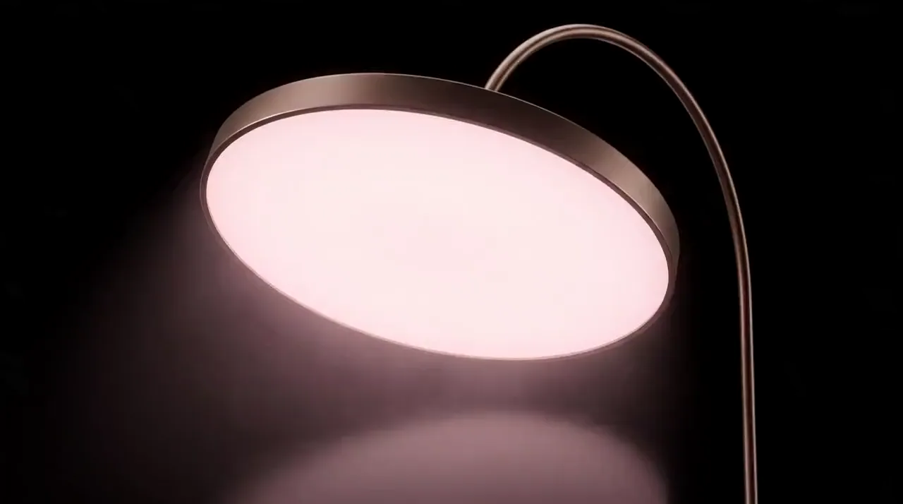 Concept film: the camera glides slowly around the head of the Instrument, a thin bronze rim around an even, glowing face, and back
