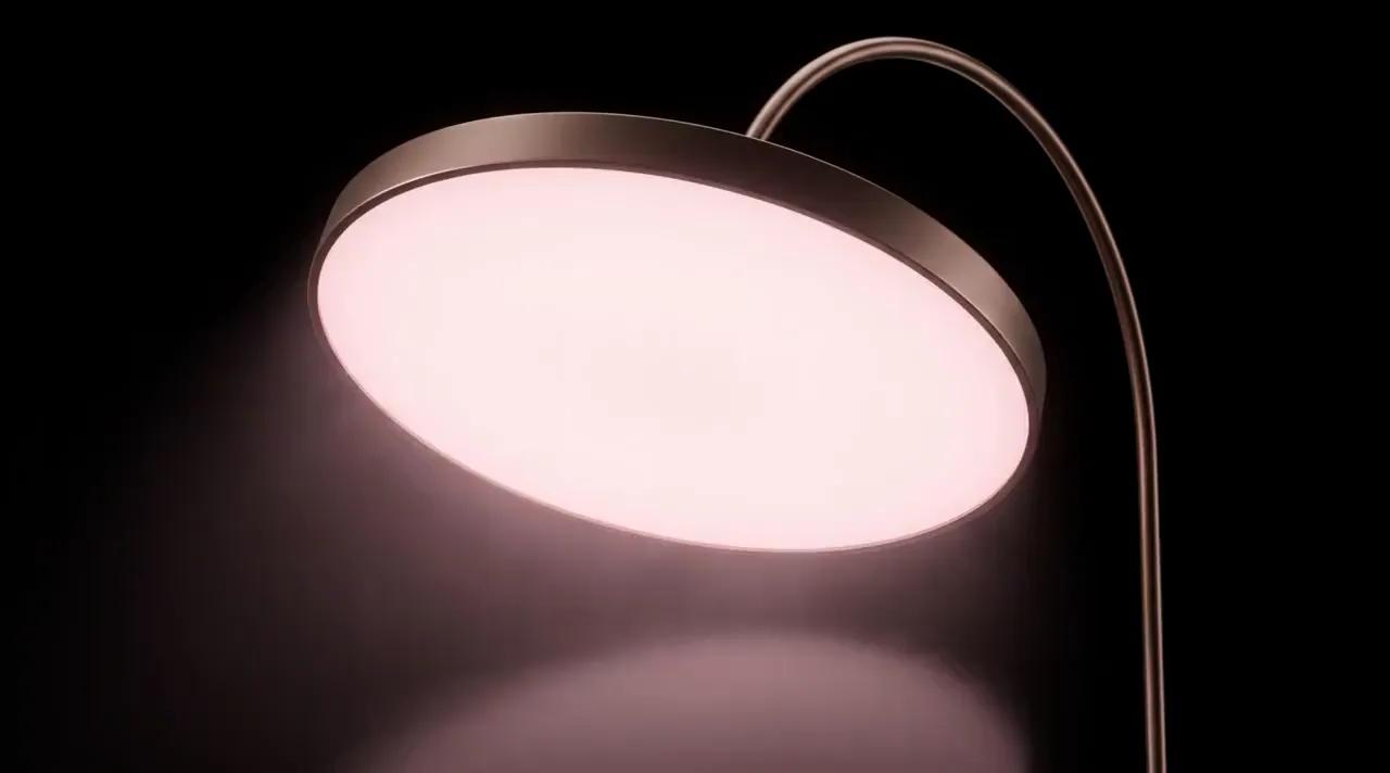 Concept render: the Instrument in a dark studio, its even pearl-rose glow breathing slowly brighter and softer